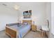 Comfortable bedroom with a wooden bed frame, neutral carpet, beach-themed decor, and a ceiling fan at 200 Arlington Dr, Placida, FL 33946