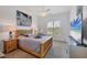 Bright bedroom with a wooden bed frame, ample natural light from the window, and beach-themed decor at 200 Arlington Dr, Placida, FL 33946