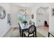 Dining area with a black table and seating for six and a chandelier at 200 Arlington Dr, Placida, FL 33946
