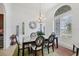 Dining area with a black table and seating for six by large arched window at 200 Arlington Dr, Placida, FL 33946