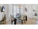 Dining room with modern table and chairs set in front of sheer curtains and a chandelier at 200 Arlington Dr, Placida, FL 33946
