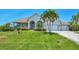 A charming home with a two-car garage, manicured lawn, and beautiful landscaping at 200 Arlington Dr, Placida, FL 33946