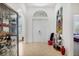 Bright foyer featuring tile flooring, arched doorways, and elegant decor at 200 Arlington Dr, Placida, FL 33946