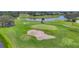 Golf course with a beautiful green, sand trap and lake at 200 Arlington Dr, Placida, FL 33946