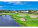 Houses overlooking a beautiful golf course, pond, and sand trap at 200 Arlington Dr, Placida, FL 33946