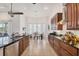 View of the kitchen and eat-in area, featuring updated wood cabinets and stainless appliances at 200 Arlington Dr, Placida, FL 33946