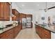Open kitchen featuring dark wood cabinetry, stainless appliances, and granite counters at 200 Arlington Dr, Placida, FL 33946