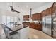 An open kitchen featuring stainless appliances, granite counters, and an eat-in island at 200 Arlington Dr, Placida, FL 33946