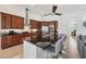 An open kitchen with wood cabinets, stainless appliances, and granite counters at 200 Arlington Dr, Placida, FL 33946