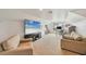 Spacious living room featuring a large TV, comfortable seating, and ample natural light at 200 Arlington Dr, Placida, FL 33946