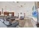 Bright open concept living room featuring a large sectional sofa and adjacent kitchen at 200 Arlington Dr, Placida, FL 33946