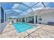 An outdoor pool area is screened in, has a brick surround, and features plenty of lounge space at 200 Arlington Dr, Placida, FL 33946