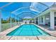 An outdoor pool area is screened in, has a brick surround, and features plenty of lounge space at 200 Arlington Dr, Placida, FL 33946