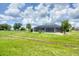 Home featuring a screen lanai surrounded by a black chain link fence and lush lawn at 2106 Damascus Ln, Punta Gorda, FL 33983