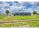 A home featuring a screen lanai is surrounded by a black chain link fence at 2106 Damascus Ln, Punta Gorda, FL 33983