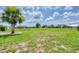 Expansive fenced in back yard with sunny skies and lush green grass at 2106 Damascus Ln, Punta Gorda, FL 33983