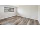 Bedroom with wood-look flooring, a ceiling fan, and natural light from the window at 2106 Damascus Ln, Punta Gorda, FL 33983