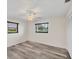 Neutral bedroom with a ceiling fan, wood-look floors, and a large closet at 2106 Damascus Ln, Punta Gorda, FL 33983