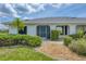 Charming entryway with stone landscaping leading to the home's screened entrance at 2106 Damascus Ln, Punta Gorda, FL 33983