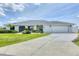 Well-maintained single-story home featuring a two-car garage, beautiful lawn, and tropical landscaping at 2106 Damascus Ln, Punta Gorda, FL 33983