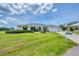 Charming single-story home with lush green lawn and well-manicured landscaping at 2106 Damascus Ln, Punta Gorda, FL 33983