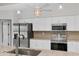 Modern kitchen features stainless steel appliances, granite counters, white cabinets, and tile backsplash at 2106 Damascus Ln, Punta Gorda, FL 33983