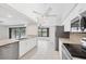 Kitchen with stainless steel appliances, tile backsplash and an opening to the dining area at 2106 Damascus Ln, Punta Gorda, FL 33983