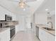 Open-concept kitchen with white cabinets, stone countertops, and modern stainless steel appliances at 2106 Damascus Ln, Punta Gorda, FL 33983
