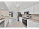 Spacious kitchen featuring modern appliances, white cabinets, and stone countertops at 2106 Damascus Ln, Punta Gorda, FL 33983