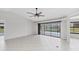 Open living area featuring tile floors, a ceiling fan, and access to the pool area through sliding glass doors at 2106 Damascus Ln, Punta Gorda, FL 33983