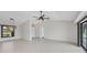 Spacious living room featuring tile floors, ceiling fan, and sliding glass doors for lots of natural light at 2106 Damascus Ln, Punta Gorda, FL 33983