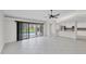 Bright and airy living area with tile floors, ceiling fan, and large sliding glass doors to pool at 2106 Damascus Ln, Punta Gorda, FL 33983