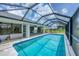 Spacious in-ground pool with a screened enclosure, perfect for outdoor relaxation and entertainment at 2106 Damascus Ln, Punta Gorda, FL 33983
