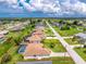 Aerial view of a single-Gathering home featuring a screened-in pool, lush lawn, and defined property lines at 25 Mariner Ln, Rotonda West, FL 33947