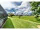 Well maintained backyard and landscaping with distant view of the neighboring houses at 25 Mariner Ln, Rotonda West, FL 33947
