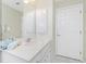 Bright bathroom features a large mirror, built in cabinets, and a white vanity at 25 Mariner Ln, Rotonda West, FL 33947