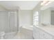 Bathroom showcasing a soaking tub, shower, marble countertops, and modern fixtures at 25 Mariner Ln, Rotonda West, FL 33947