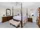 Traditional bedroom featuring a four-poster bed, neutral walls, and elegant furnishings at 25 Mariner Ln, Rotonda West, FL 33947