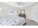 Bedroom featuring a gray dresser, white trim and a bed with blue and white patterned bedding at 25 Mariner Ln, Rotonda West, FL 33947