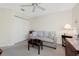 Relaxing bedroom features a loveseat, ceiling fan, and double door closet at 25 Mariner Ln, Rotonda West, FL 33947