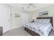 Bedroom featuring a ceiling fan, closet and a bed with beautiful blue and white patterned bedding at 25 Mariner Ln, Rotonda West, FL 33947