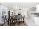 Open floorplan: dining area with access to the kitchen and views of the pool area at 25 Mariner Ln, Rotonda West, FL 33947