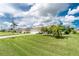 Front lawn with palm trees and well-manicured lawn at 25 Mariner Ln, Rotonda West, FL 33947