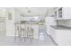 An efficient kitchen with white cabinets, sleek countertops, and a cozy breakfast bar, ideal for modern living and dining at 25 Mariner Ln, Rotonda West, FL 33947