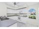 Bright kitchen with white cabinets, granite countertops, and a garden window at 25 Mariner Ln, Rotonda West, FL 33947
