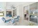 Covered lanai with fan, outdoor furniture, and views into the home at 25 Mariner Ln, Rotonda West, FL 33947