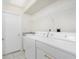 Practical laundry room with washer, dryer, utility sink and storage space at 25 Mariner Ln, Rotonda West, FL 33947