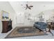 Bright living room features a fireplace, ceiling fan, tile floors, and comfortable seating at 25 Mariner Ln, Rotonda West, FL 33947