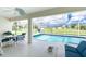 Covered lanai area featuring a pool with lounge chairs and outdoor dining table at 25 Mariner Ln, Rotonda West, FL 33947