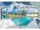 Inviting in-ground pool with large screened in lanai with beautiful blue skies at 25 Mariner Ln, Rotonda West, FL 33947